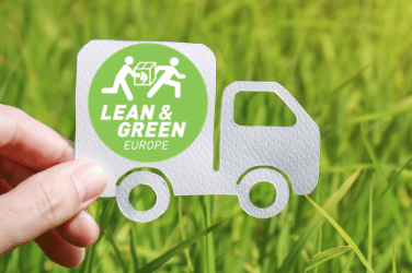 Lean and Green Paper Truck Paper Lorry Against Grass