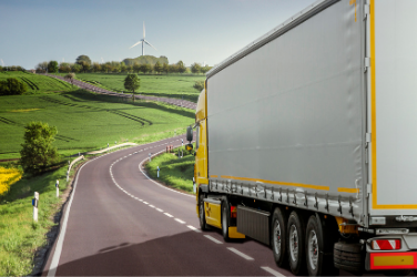 Truck Travelling On A Road In Fields